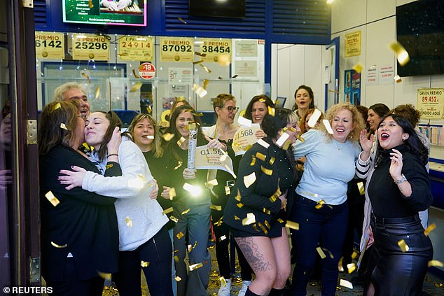 Workers at Dona Manolita celebrate the sale of three lottery numbers for the fifth prize in the Spanish Christmas lottery "El Gordo" (The Fat One), in Madrid, Spain, December 22