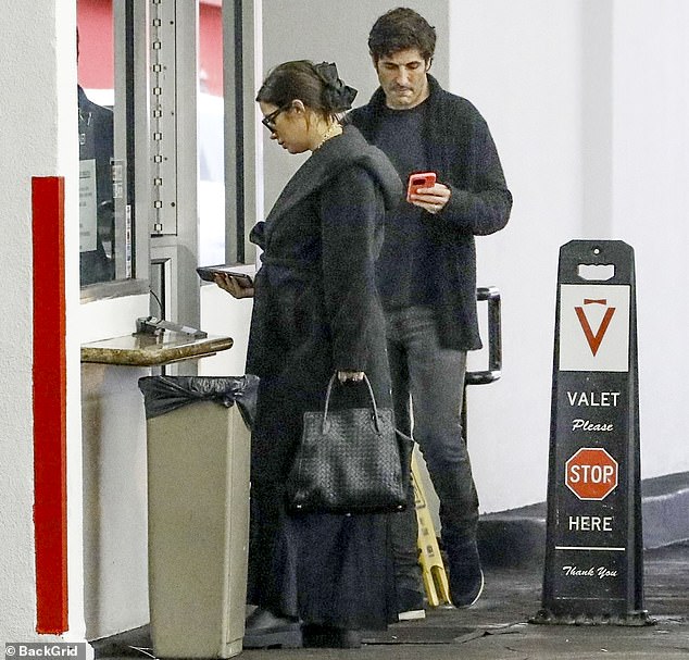 The Pretty Little Liars actress, who recently put on a loved-up show during a sushi date, donned a fashionable oversized black coat and matching top as she spent time with her partner