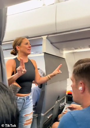 A woman's meltdown was caught on video as she frantically demanded to get off a plane, claiming someone in the back of the plane wasn't real