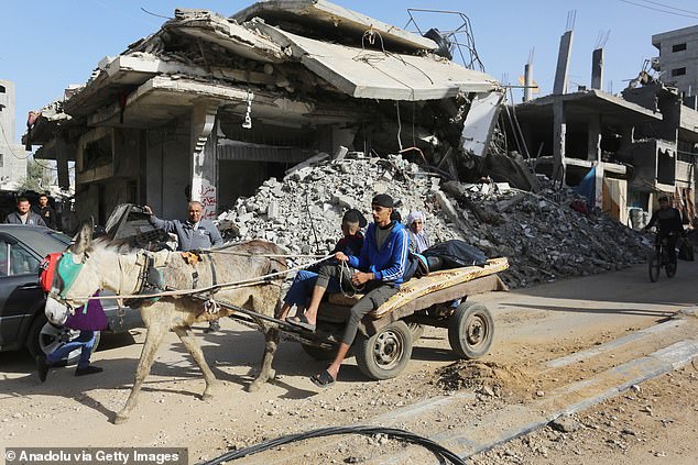 Palestinians living in the Bureij refugee camp leave their homes with their belongings to head towards the city of Deir al-Balah after the Israeli forces asked them to leave the camp in Bureij, Gaza, on December 22, 2023.