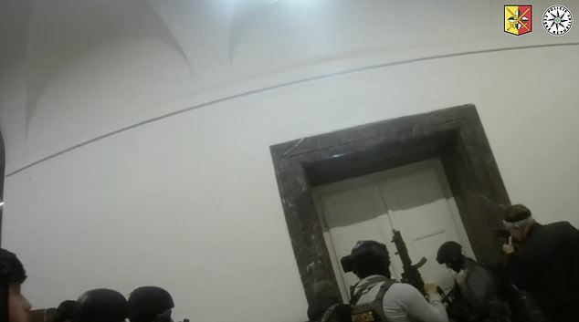 Inside the building, armed officers can be seen surrounding a door that was barricaded by terrified students and teachers who heard the gunshots and did not have time to flee.