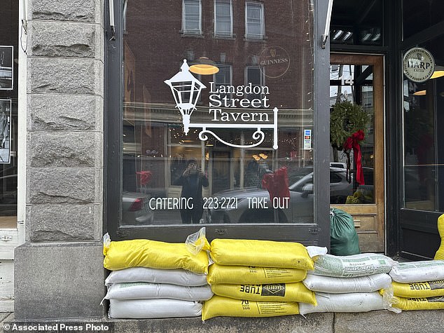 Parts of the country have been issued a Level 2 warning for flash flooding, threatening to further derail travel plans.  Pictured: Sandbags litter the streets of Montpelier, Virginia, on Tuesday, December 19, 2023, a day after the threat of flooding hit the city again