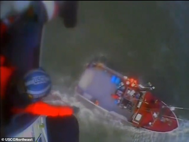 Footage released by the US Coast Guard Northeast shows two crew members being lifted by an MH-60 Jayhawk helicopter