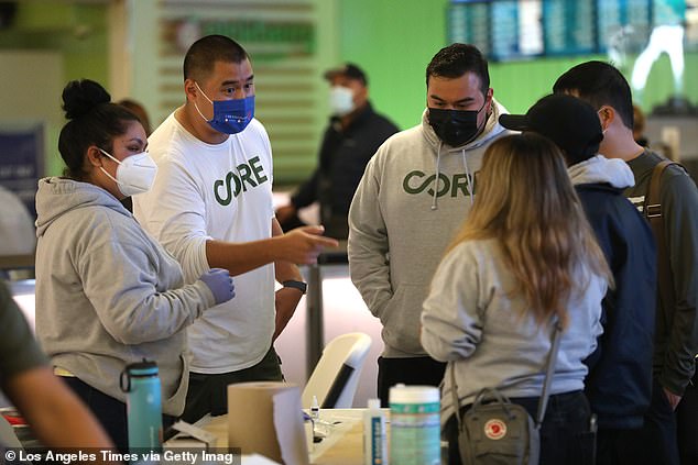 Community Organized Relief Effort (CORE) employees discuss before opening free COVID-19 rapid testing in 2021 led by the employee site at Los Angeles International Airport