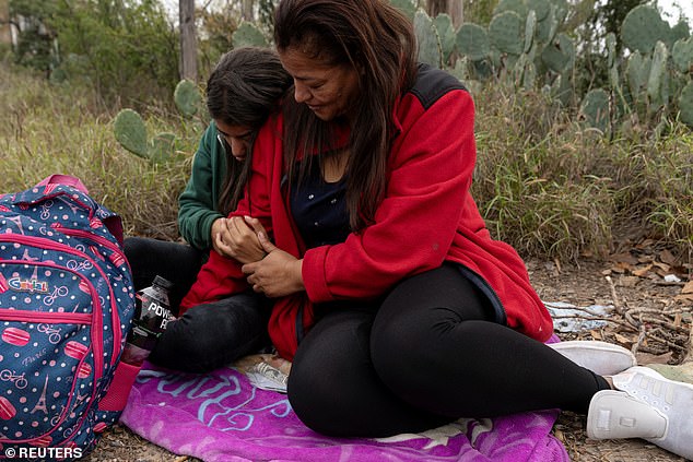 Nancy Guzman, 40, comforts her daughter Jackeline Hernandez, 18, as she is apprehended by Border Patrol after wading across the Rio Grande River