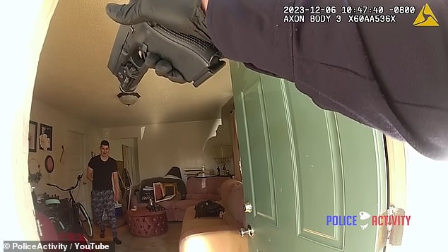 Reno Nevada Police Department deputy is seen pointing the gun at Briggs after they were called to the home around 10:45 a.m. on December 6 following multiple reports of a woman frantically screaming for help and saying a man was in her house was killing Another woman.