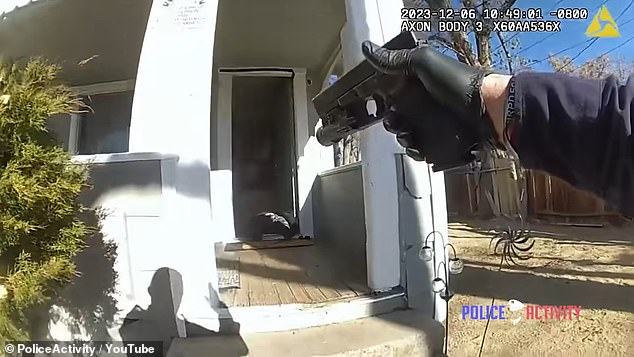 Briggs is seen in the video after being shot face up in the doorway of his home as the officer continues to point his gun and call on his radio for help.