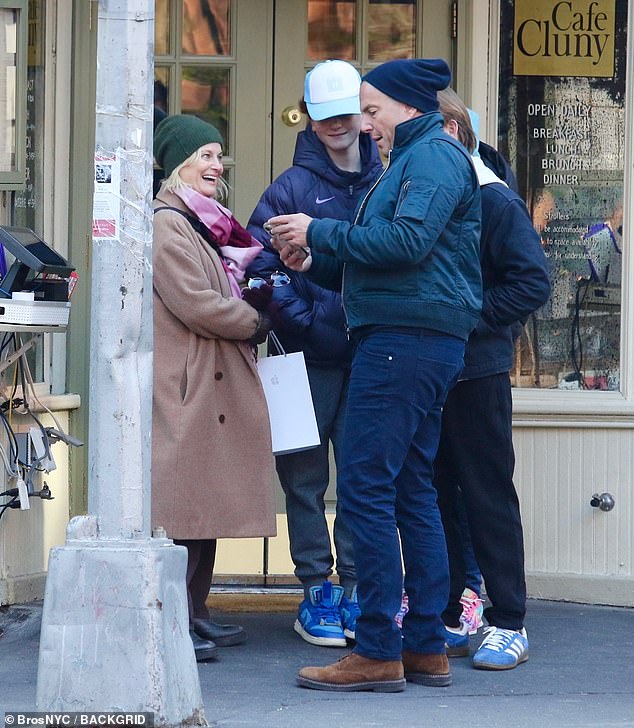 The Parks and Recreation actress wore a camel brown trench coat during their outing.  She also kept warm by wearing an olive green hat, burgundy gloves and a pink scarf