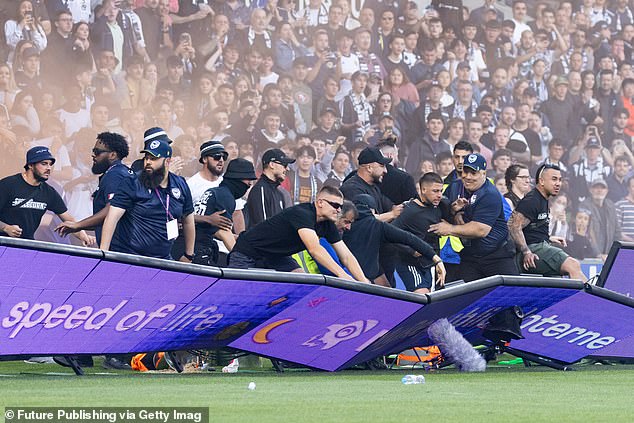 The crowd pushed their way past police and security to reach the field and the players