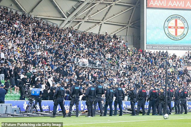 Sensing the tension, police and security formed a barricade just before the pitch invasion took place