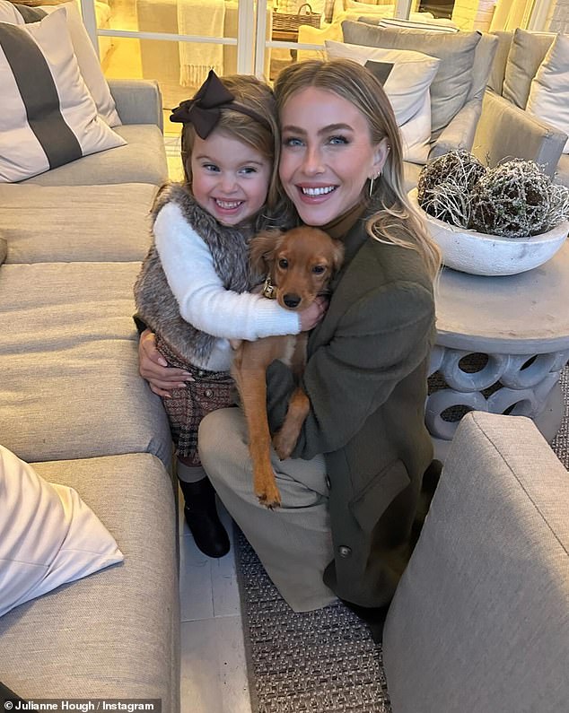 In one of the photos, she crouched down and posed with her friend Nanci Dahl's daughter as they cuddled Julianne's precious pooch together