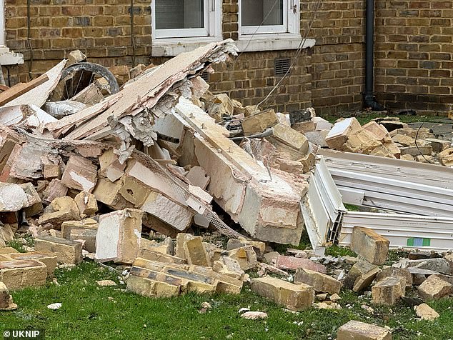 Bricks, windows, furniture and other debris were strewn across the grass outside the property