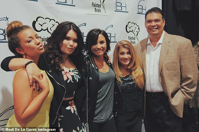 She is the actress Madison De La Garza (in the photo second from the left next to half-sister Demi Lovato)