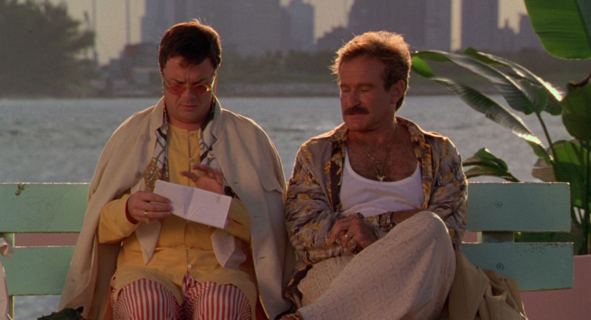 Nathan Lane and Robin Williams sit on a bench in The Birdcage.