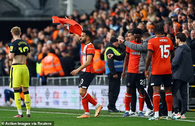 The winger ran to the home bench and held up the Luton captain's shirt after his goal