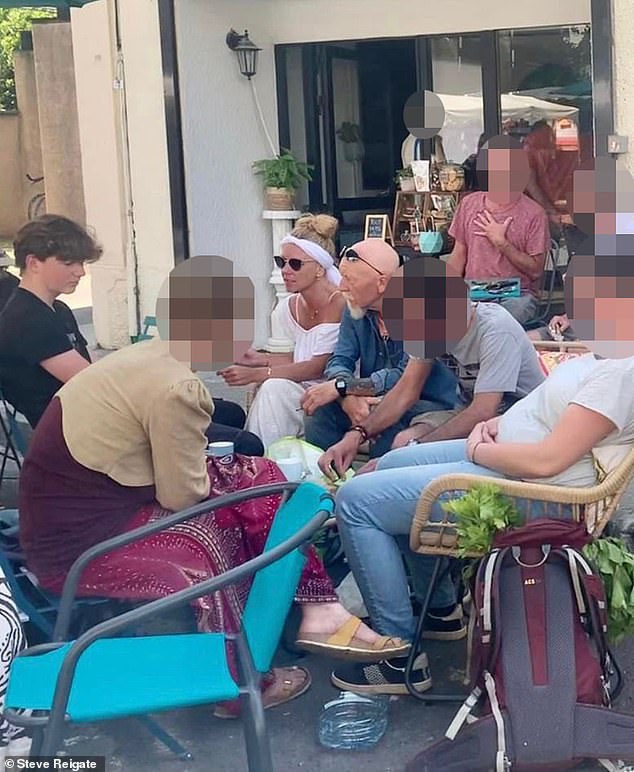 Melanie Batty sits next to her father David Batty and her son Alex Batty (far left) at a market in June 2023