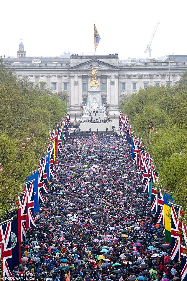 The King's message was recorded in the Center Room of the Palace, which opens onto the balcony and overlooks The Mall, where crowds gathered to celebrate the coronation in May (pictured)