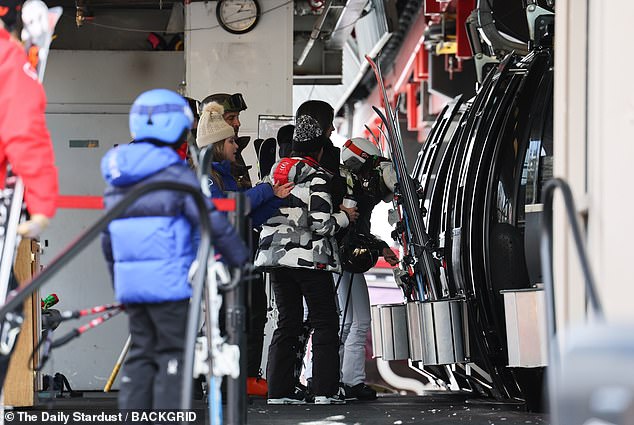 They were all dressed in cozy winter clothes and helped each other load their skis