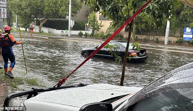 Sydney received heavy rainfall on Sunday afternoon, hitting the city's eastern suburbs with flash flooding that left vehicles stranded (pictured)