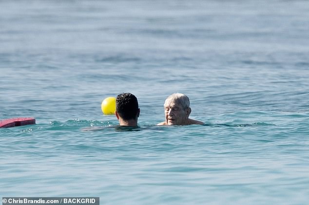 The 93-year-old was also spotted taking a dip in the water with members of his entourage