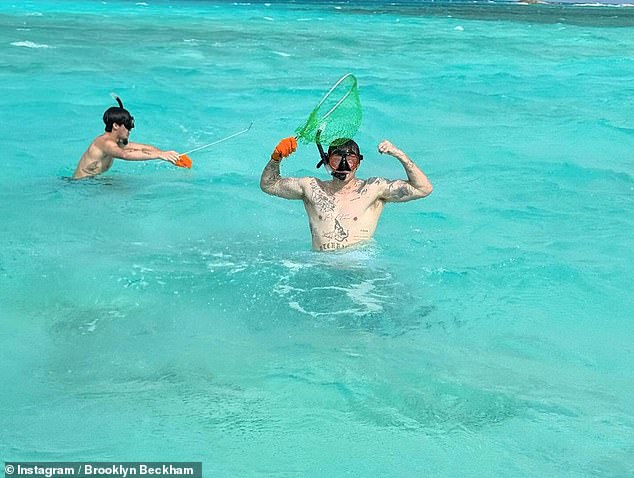 A final photo showed Brooklyn and Romeo fishing in the clear blue water, while Brooklyn showed off his impressive tattoo collection