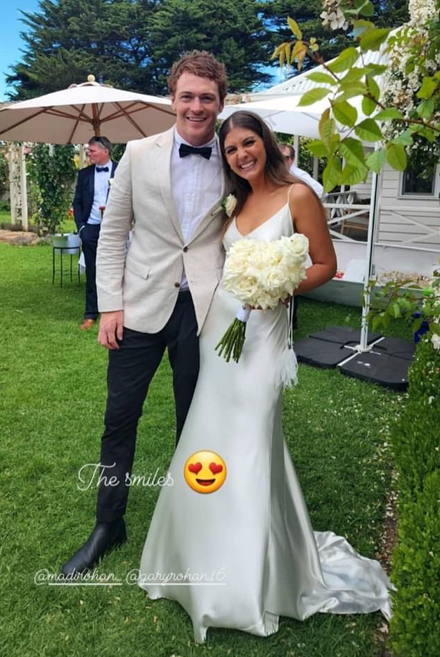 The footy star went public in 2021 with Geelong physio Madi (right), and the happy couple officially married in December 2022