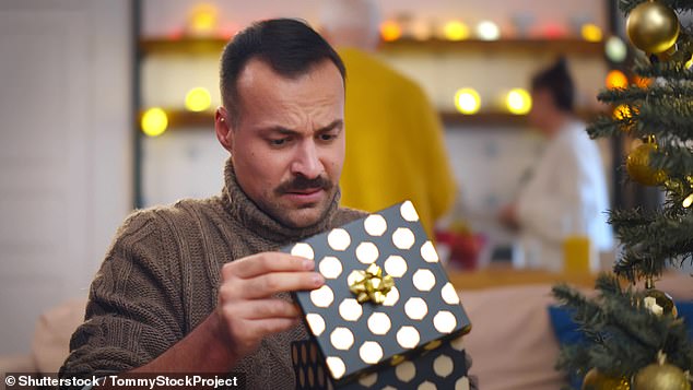 A new survey has found that more than a third of Brits (36%) routinely fake their reactions to what they find under the tree (stock image)