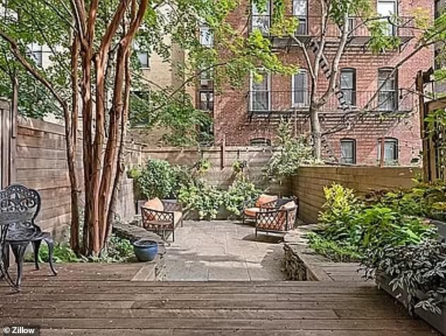 The garden offers a “serene retreat” with mature trees, a wooden deck and a bluestone patio, according to the listing