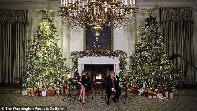 President Donald Trump and first lady Melania Trump speak on the phone with children as they track Santa Claus with the North American Aerospace Defense Command, NORAD, in 2018