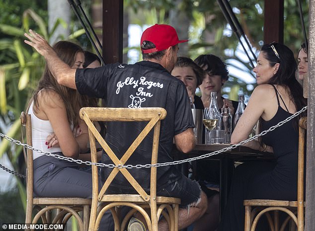 The two families chatted at the table