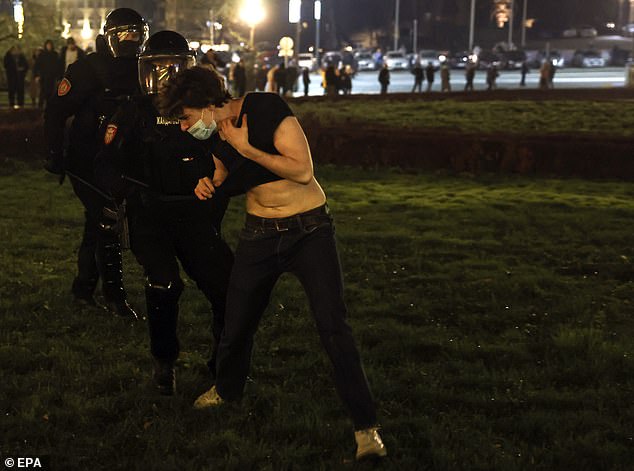 A male opposition supporter is arrested by police