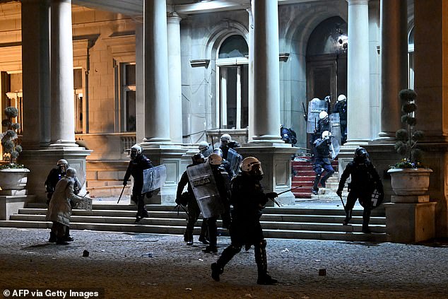 Shielded riot police barricade themselves in Belgrade City Hall