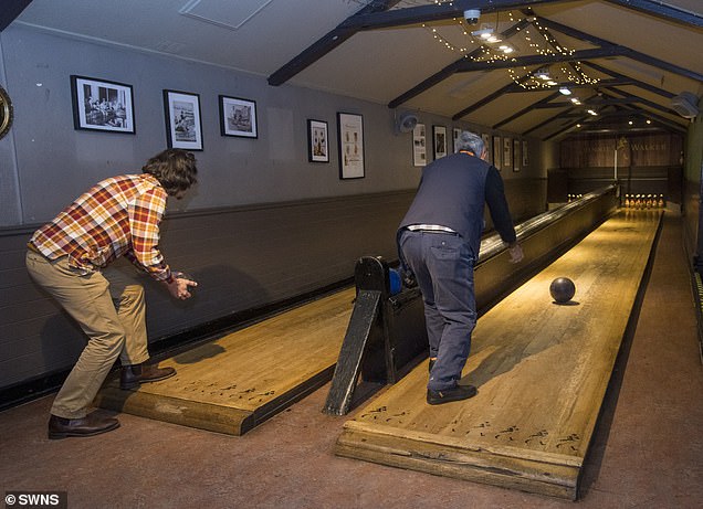 James and William Chow recreate a 1903 photo of the bowling alley at The Sheep Heid Inn, Duddingston, Edinburgh