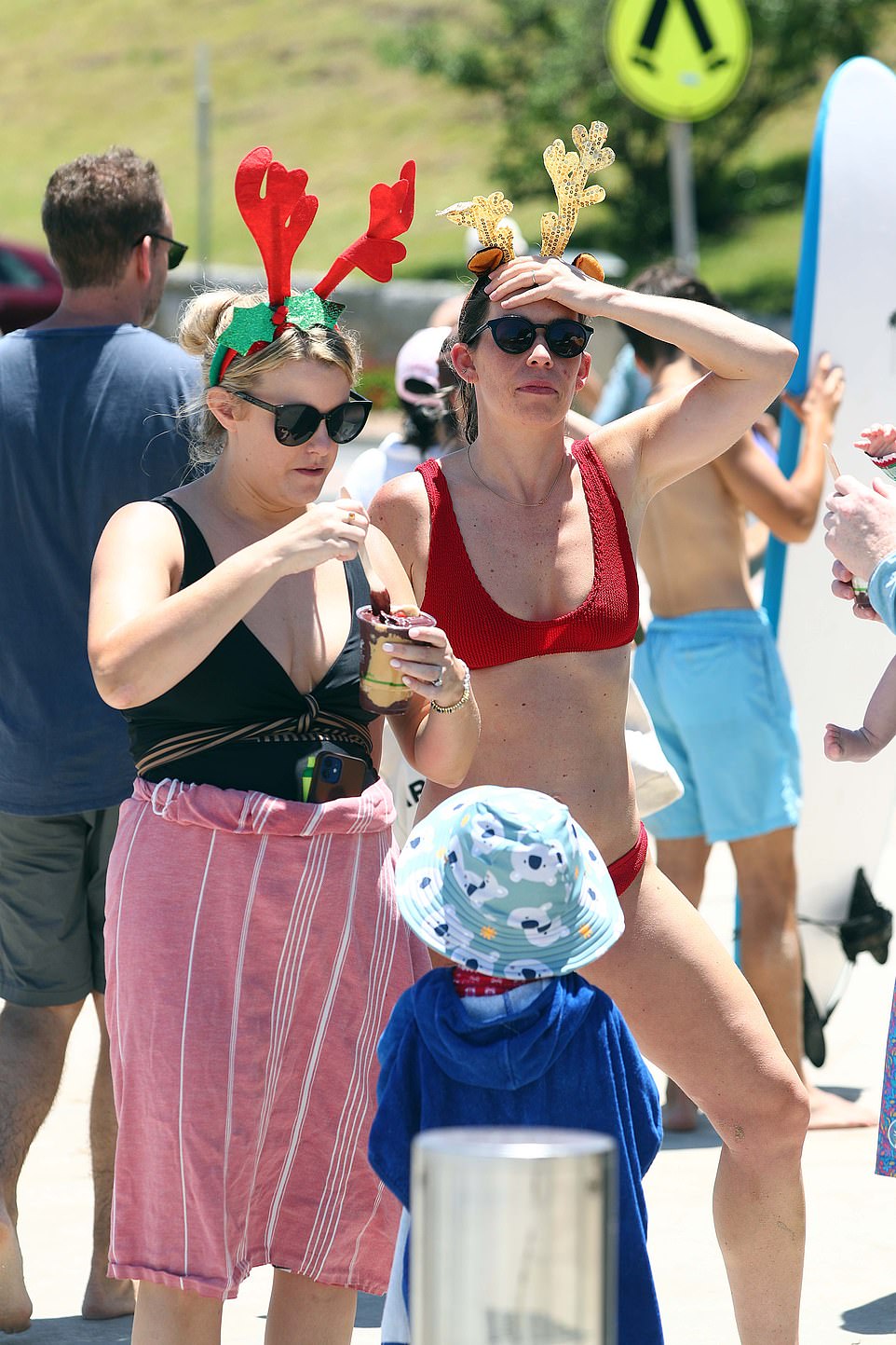 Two women are seen wearing reindeer ears after a day at the beach