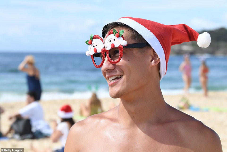 A man is seen wearing festive glasses during a trip to Bondi at Christmas