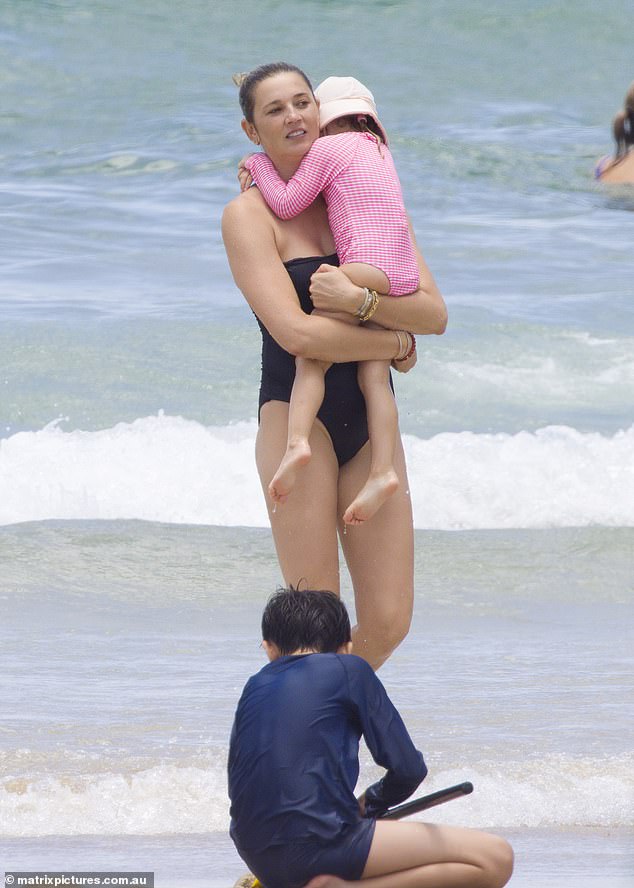 After the little girl cried out in distress, Jasmine carried the toddler out of the water