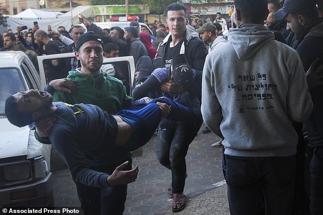 Palestinians injured in the Israeli bombardment of the Gaza Strip are taken to hospital in Deir al Balah, Gaza Strip, on Sunday, December 24, 2023.  (AP Photo/Adel Hana)