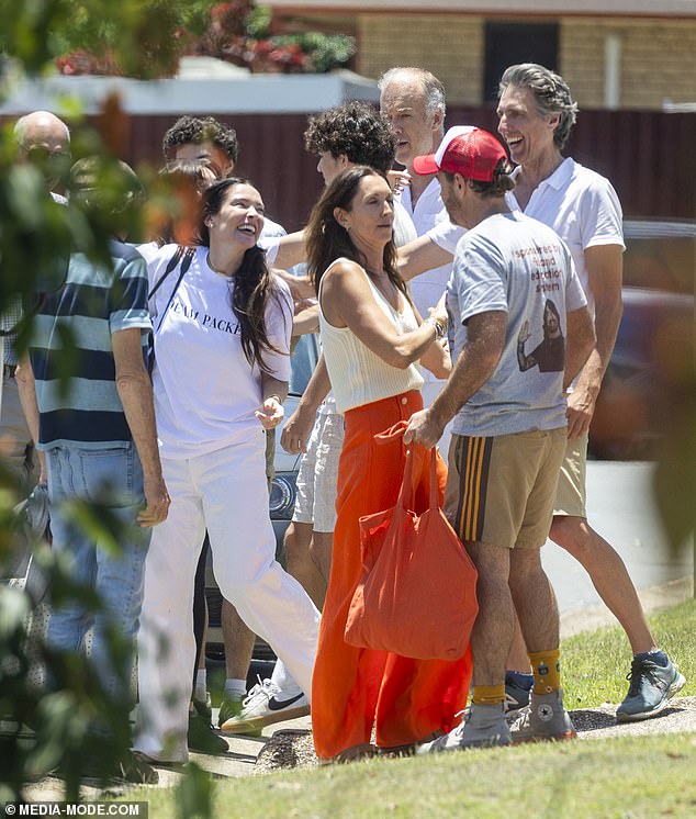 Shannon, 48, the ex-partner of actress Madeleine West, paired his look with a custom red and white baseball cap and brown shorts