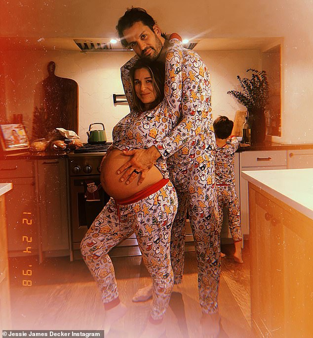 The songwriter's 36-year-old husband lovingly held his wife's baby bump as they posed for a moment