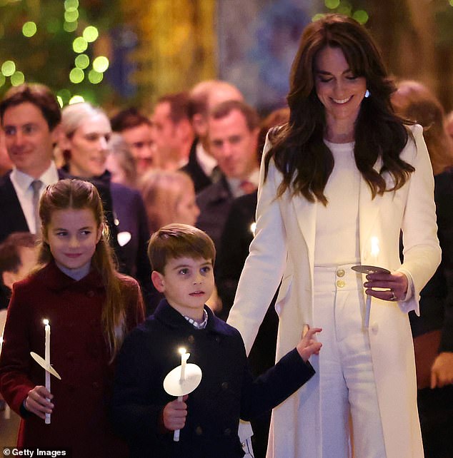 The Princess of Wales and Princess Charlotte (left) smile as Prince Louis (centre) watches the carol service recorded earlier this month