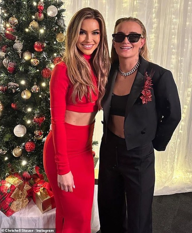 Chrishell and G posed dashingly in front of a Christmas tree in a festive photo on Instagram