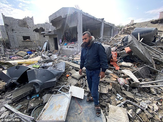 Palestinian man Ibrahim Al-Haj Youssef, who lost four of his children and his wife in an Israeli airstrike, stands among the rubble in the Maghazi camp on Christmas Day