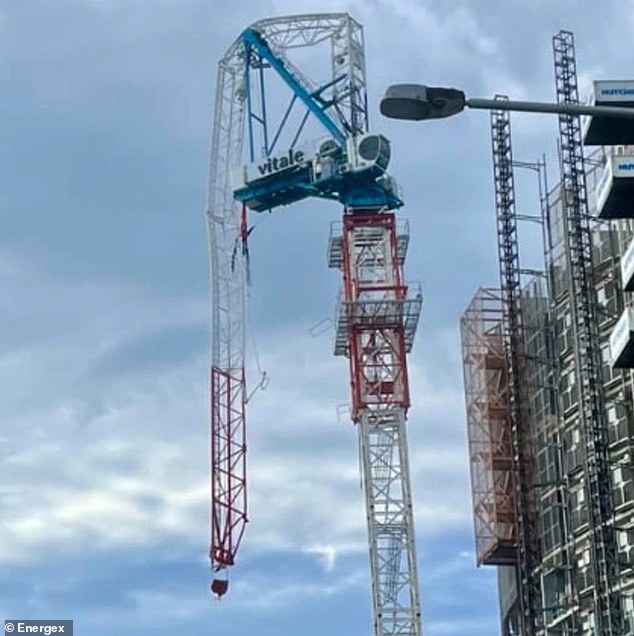 A crane in Burleigh Heads on the Gold Coast was torn apart by the wind (pictured)