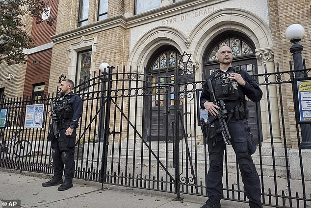 Hoboken police stand guard outside a synagogue in their New Jersey city.  One group says 199 journalists 'swatted' at Jewish facilities in one day