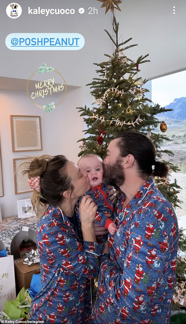 She also shared a photo of both parents kissing their daughter's cheeks, all in matching blue pajamas, with the actress tagging clothing store Posh Peanut.