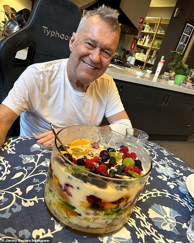 In another image, the legendary rocker is seen grinning in front of an epic trifle decorated with berries, kiwis and more