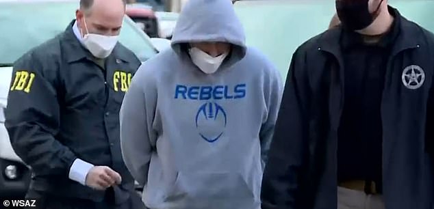 Evans, wearing a Tolsia Rebels High School sweatsuit, was arrested by the FBI days after the riot