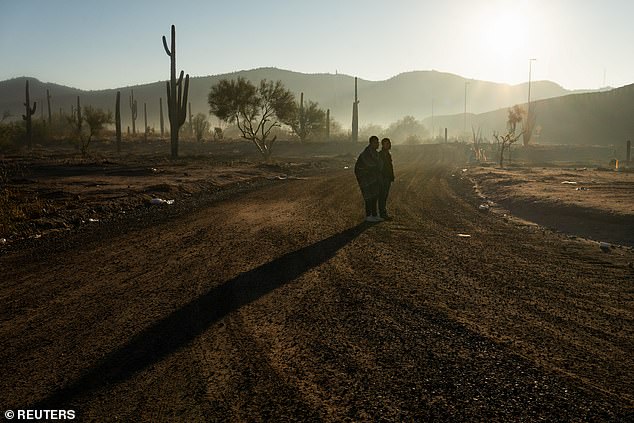 Migrants wait to be transported by Border Patrol agents at the U.S.-Mexico border near Lukeville, Arizona, U.S., December 25, 2023