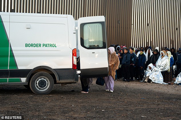 Migrants board a Border Patrol transport van at the U.S.-Mexico border near Lukeville, Arizona, U.S., December 25, 2023