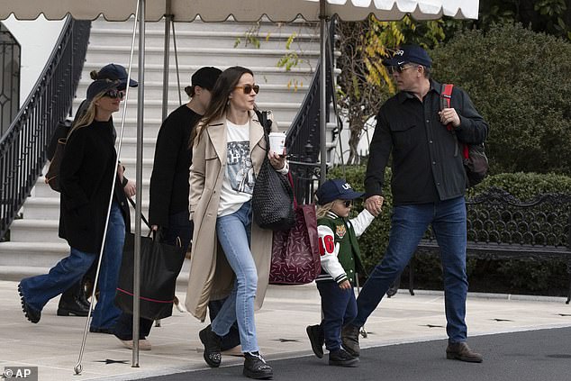 President Joe Biden's son Hunter Biden, right, walks with his son Beau Biden, wife Melissa Cohen Biden, back left, and sister Ashley Biden, center, aboard Marine One before departing for Camp David on Saturday